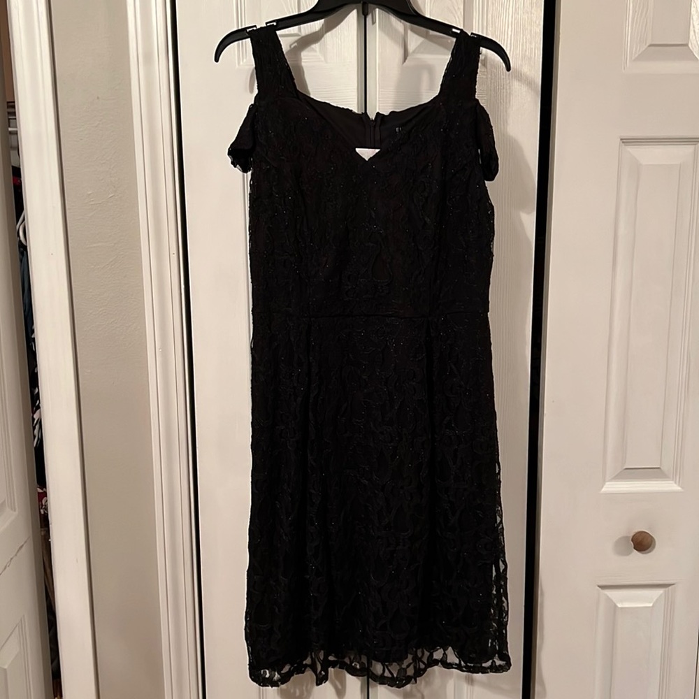 Knee length black dress. Zips in the back. Size 12